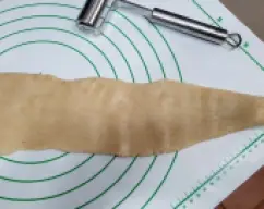 Step <p>deja los dos extremos con la forma de cilindro (serán la cola y la cabecita de la serpiente o anguila) y aplasta con las mano o un rodillo pequeño el resto del cilindro.</p> illustration